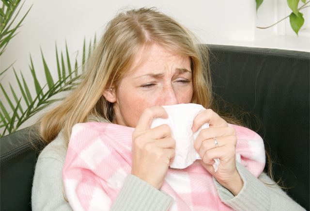 Unwell women drinking a cup of tea